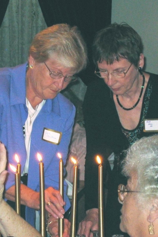 Joyce and Loretta Lighting candle for Darlene Frantum Swanson